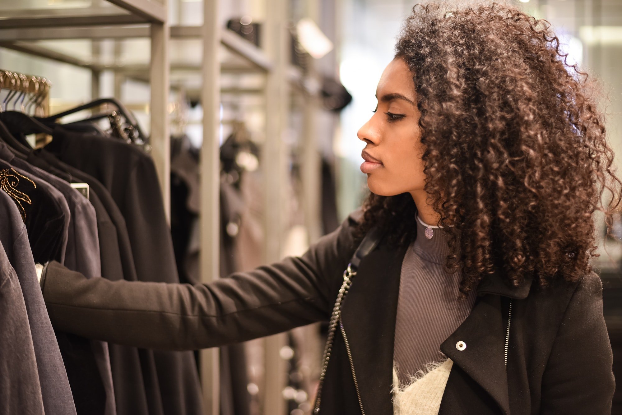 Black young woman doing shopping in a store